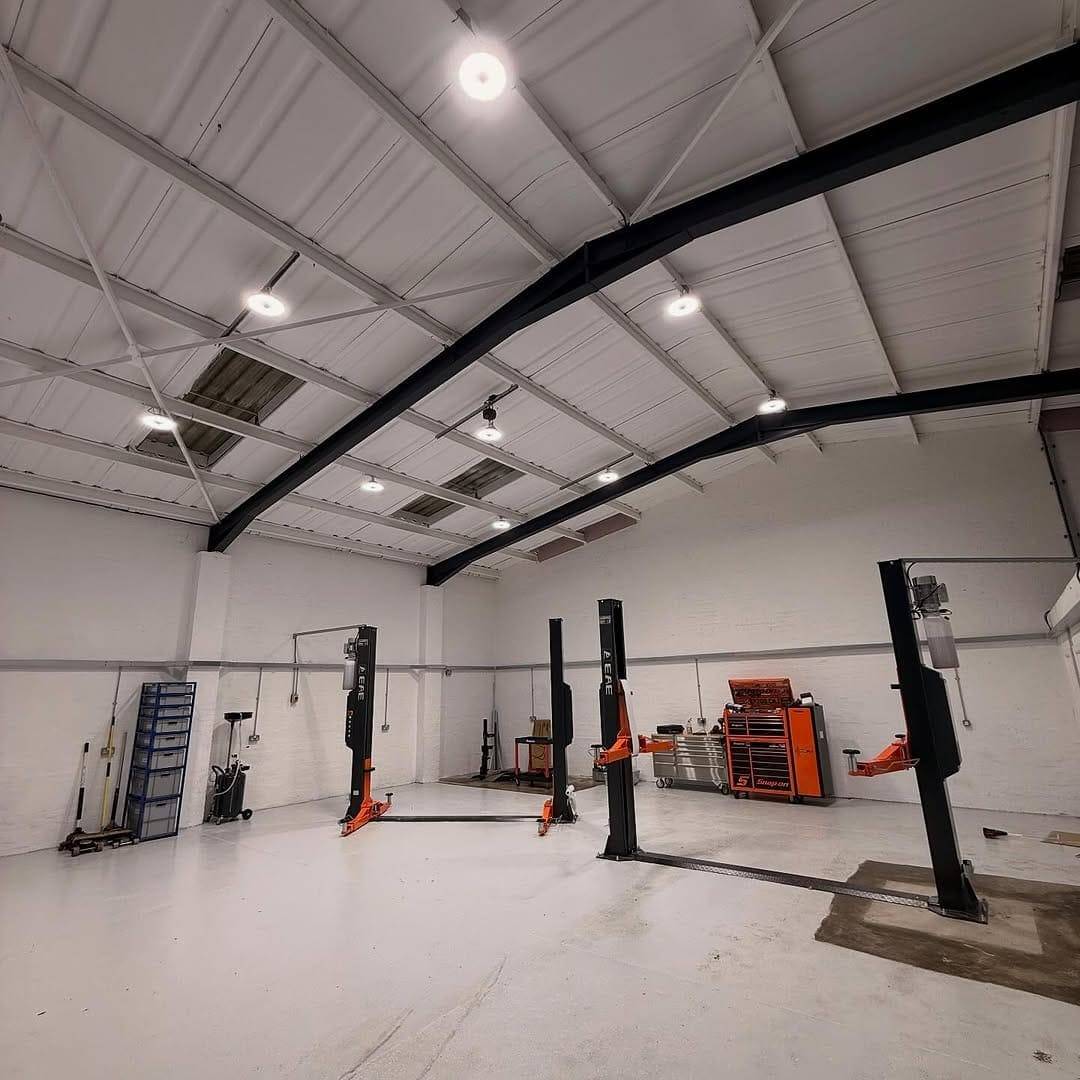 Workshop fit-out by Renovolt in a Bridgend garage: low-bay LED lights over the vehicle ramps